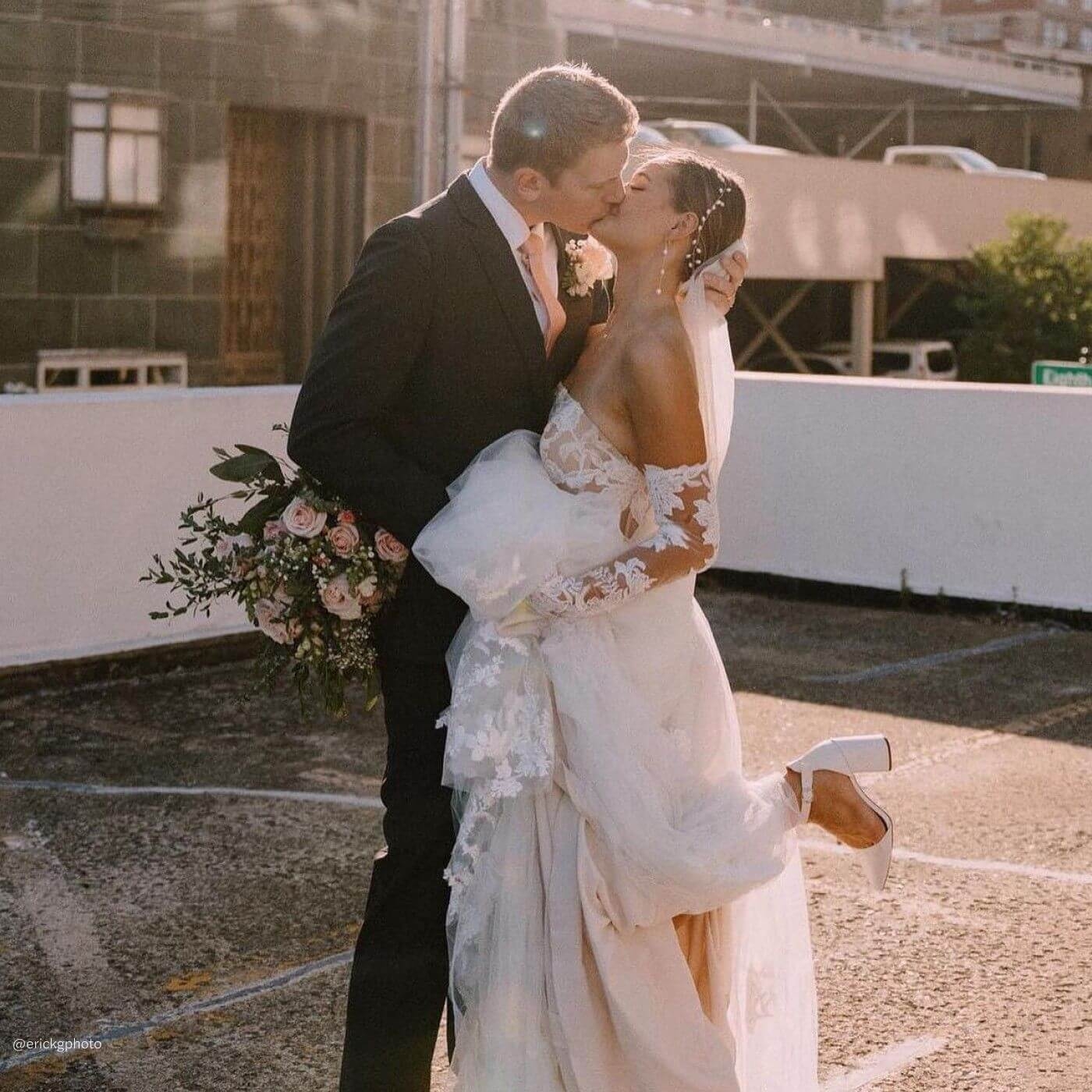 Сouple wearing a white gown and a black suit