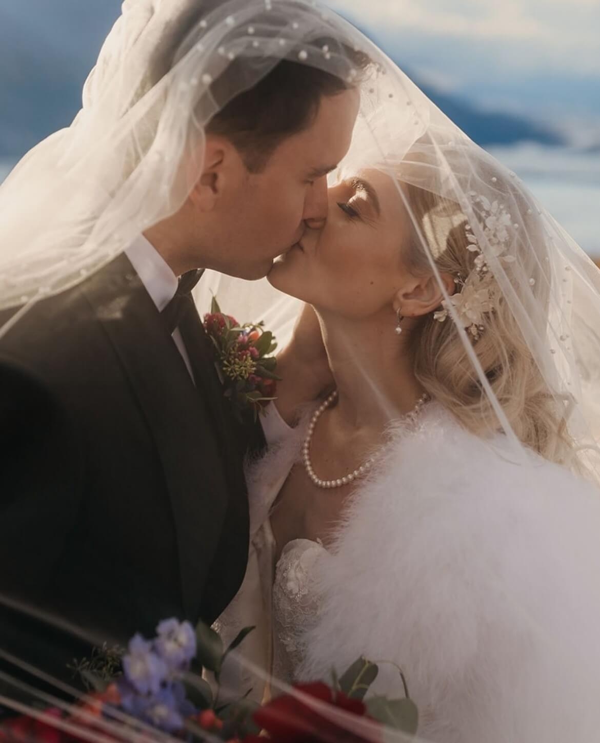 Сouple wearing a white gown and a black suit