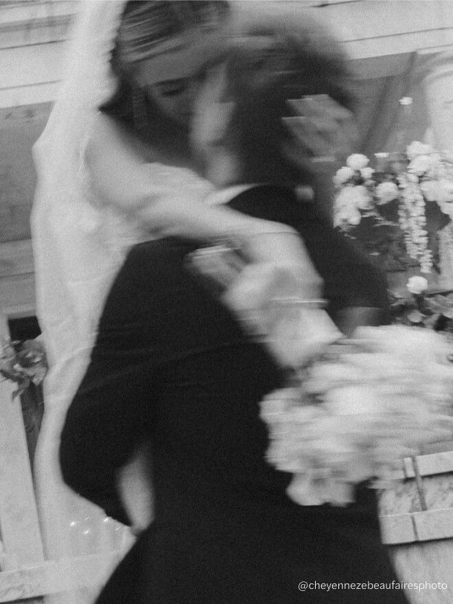 Сouple wearing a white gown and a black suit black and white photo